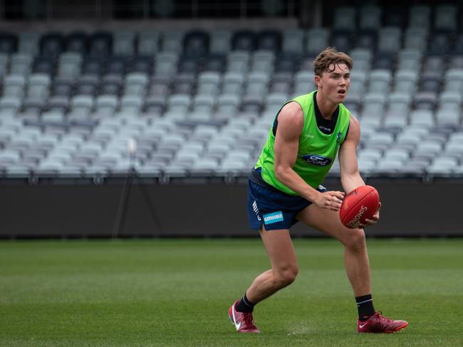 Tanner Bruhn looks to handball. Picture: Geelong Cats Media