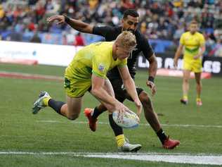 HIGHLIGHT GOLD: Two years ago Lachie Miller was playing both league and union on the Coffs Coast. Now the St John Paul College product is blitzing the HSBC World Sevens Series. Here he scores a try in front of New Zealand's Amanaki Nicole in the third play-off at the Los Angeles Sevens on Sunday.     . Picture: Ringo H.W. Chiu