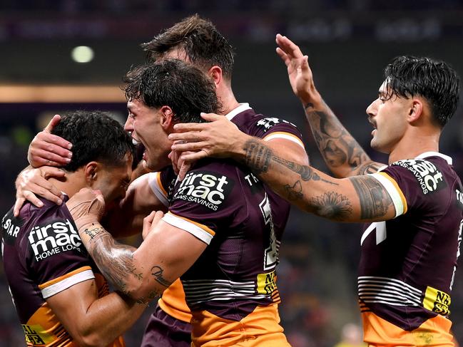 BRISBANE, AUSTRALIA - AUGUST 31: Jordan Pereira of the Broncos is congratulated by team mates after scoring a try during the round 27 NRL match between the Brisbane Broncos and Melbourne Storm at Suncorp Stadium on August 31, 2023 in Brisbane, Australia. (Photo by Bradley Kanaris/Getty Images)