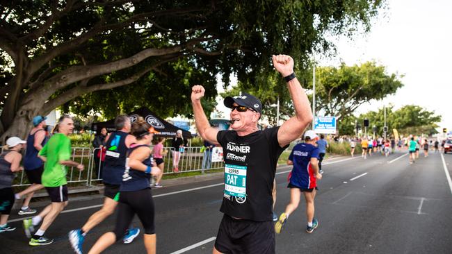 Marathon ambassador and pace setter Pat Carroll cheers on fellow runners at the Gold Coast Marathon