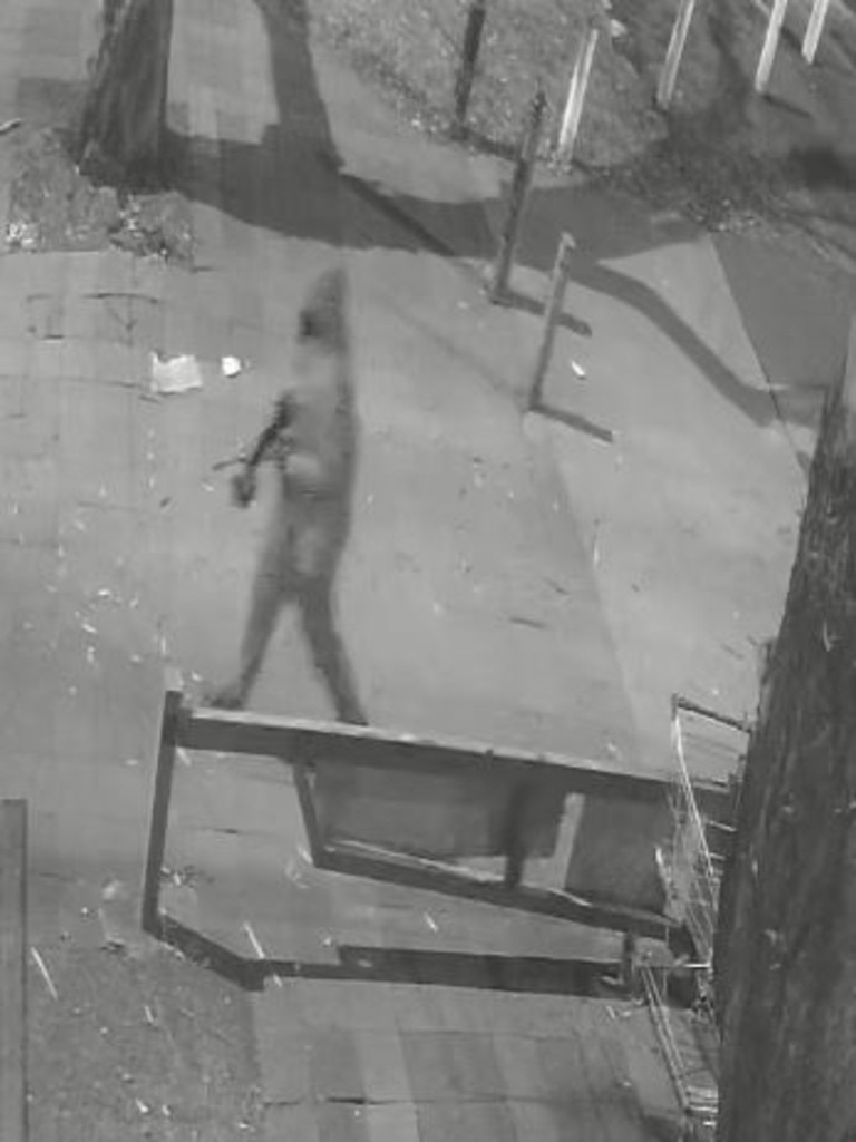 Two figures, one seen with a large gun, captured on CCTV after a shocking alleged shooting. Picture: Supplied