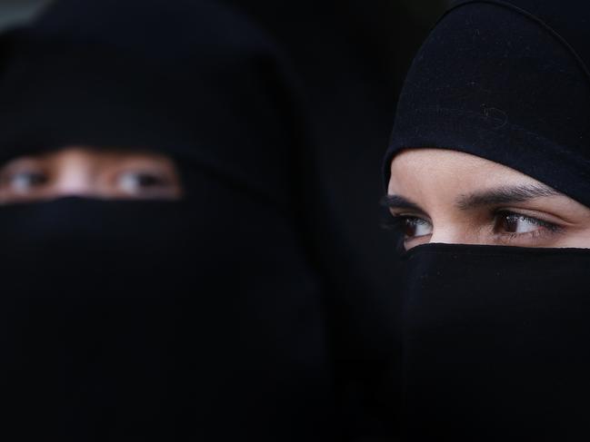 LONDON, ENGLAND - APRIL 11: Two women wearing Islamic niqab veils stand outside the French Embassy during a demonstration on April 11, 2011 in London, England. France has become the first country in Europe to ban the wearing of the veil and in Paris two women have been detained by police under the new law. (Photo by Peter Macdiarmid/Getty Images)