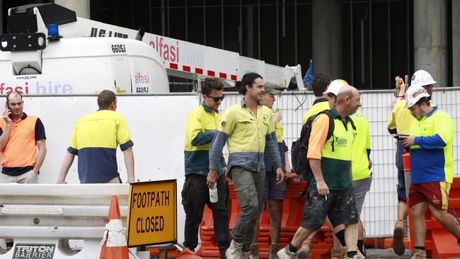 Workers leave the Jewel worksite in Surfers Paradise after three workers were injured on the site. Photo: Tertius Pickard