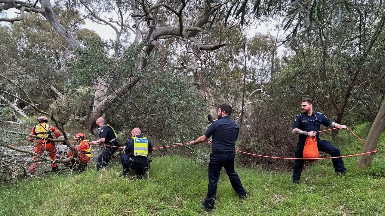 Emergency workers rescuing a woman from flood waters after heavy rain at the Buchan campground in east Gippsland on December 27. (Photo by Handout / VICTORIA POLICE / AFP)