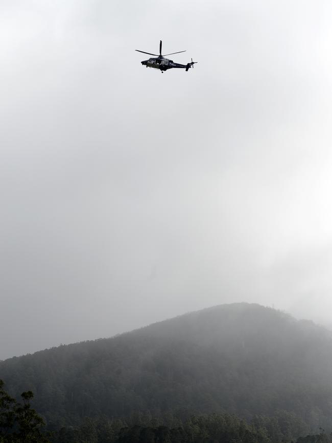 A police helicopter flies over Warburton. Picture: Andrew Henshaw