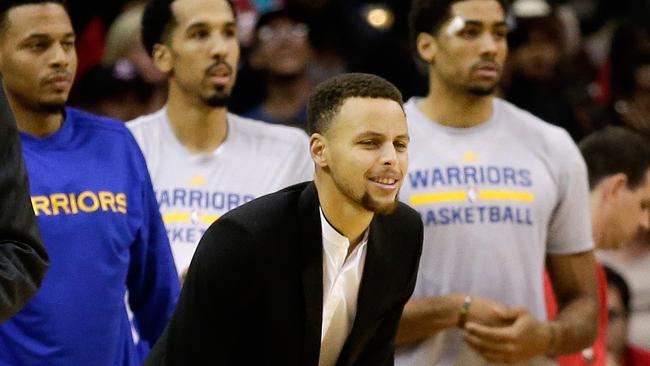 Stephen Curry of the Golden State Warriors looks on from the bench.
