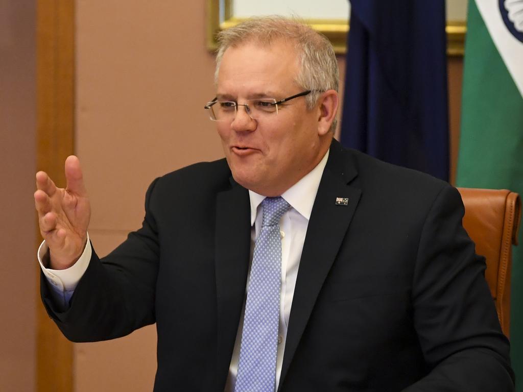 Prime Minister Scott Morrison at a previous leaders summit speaking to Indian Prime Minister Narendra Modi. Picture: AAP