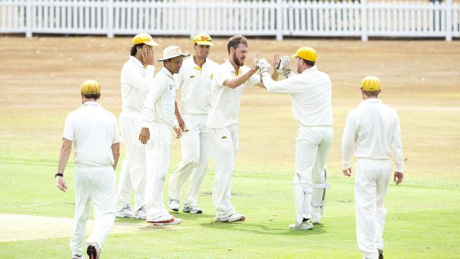 Western Suburbs come together to celebrate a wicket. (AAP Image/Richard Walker)