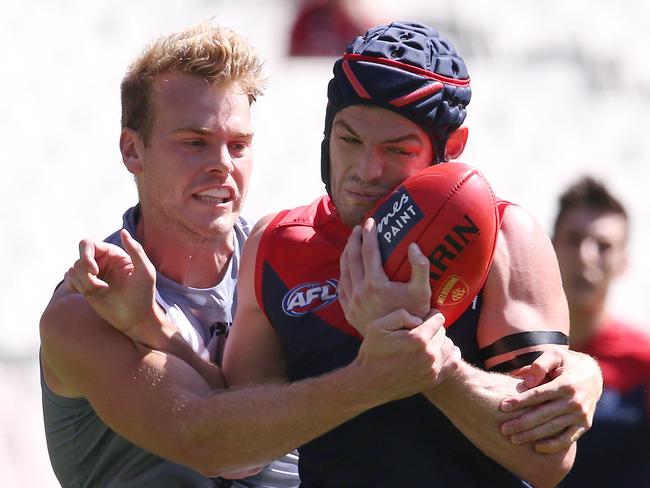 Jack Watts lays a strong tackle on ex-Demons teammate Angus Brayshaw last Saturday. Picture: Michael Klein.