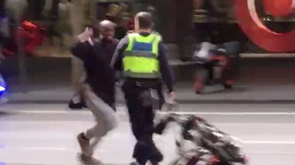 A police officer comes face-to-face with terrorist Hassan Shire Ali on Bourke St.