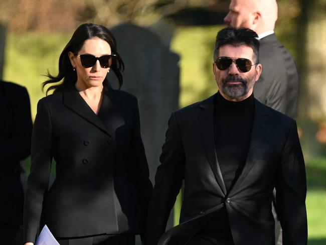 Simon Cowell and Lauren Silverman leave after attending the funeral service. Picture: AFP