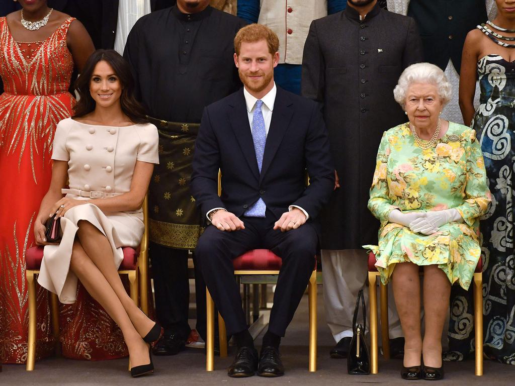 Meghan, Duchess of Sussex, Britain's Prince Harry, Duke of Sussex and Britain's Queen Elizabeth II pose for a picture during the Queen's Young Leaders Awards Ceremony at Buckingham Palace in London. Picture: AFP