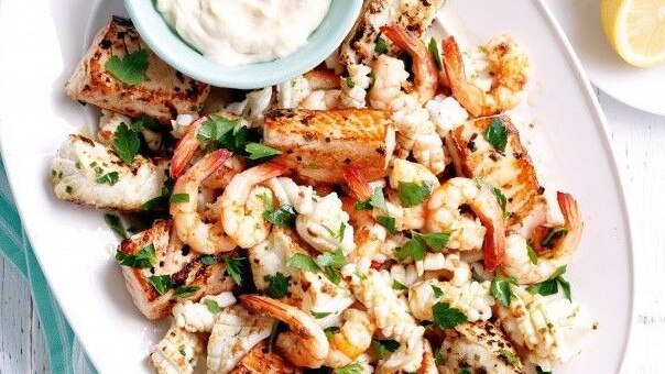 Sizzling seafood platter with aioli.