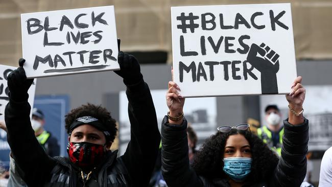 Protesters holding signs during Melbourne’s BLM protest in June. Picture: AFP