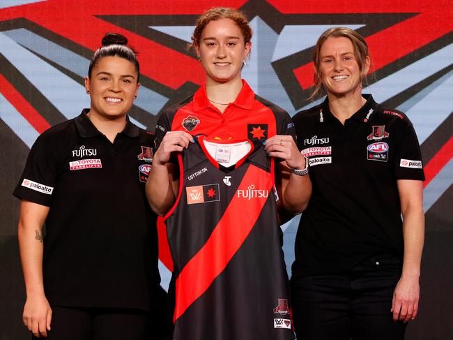 MELBOURNE, AUSTRALIA - JUNE 29: Number 4 pick Amber Clarke of the Bombers poses with Madison Prespakis (left) and Natalie Wood, Coach of the Bombers during the 2022 NAB AFLW Draft at Marvel Stadium on June 29, 2022 in Melbourne, Australia. (Photo by Michael Willson/AFL Photos via Getty Images)