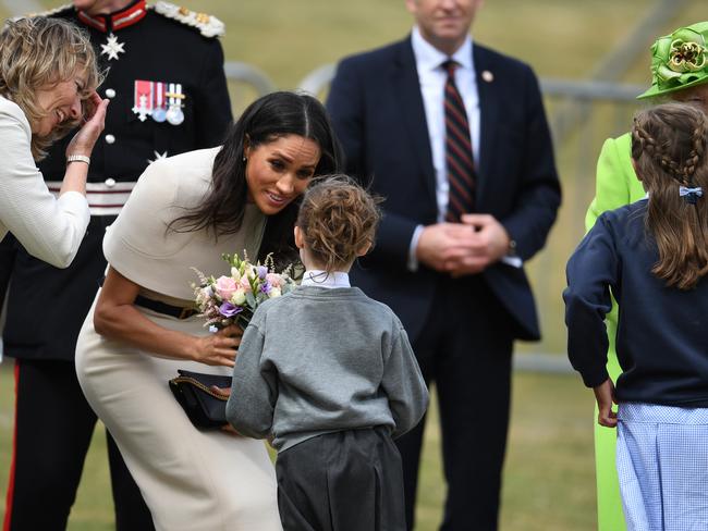 Meghan, Duchess of Sussex, receives flowers from a young girl. Picture: Getty