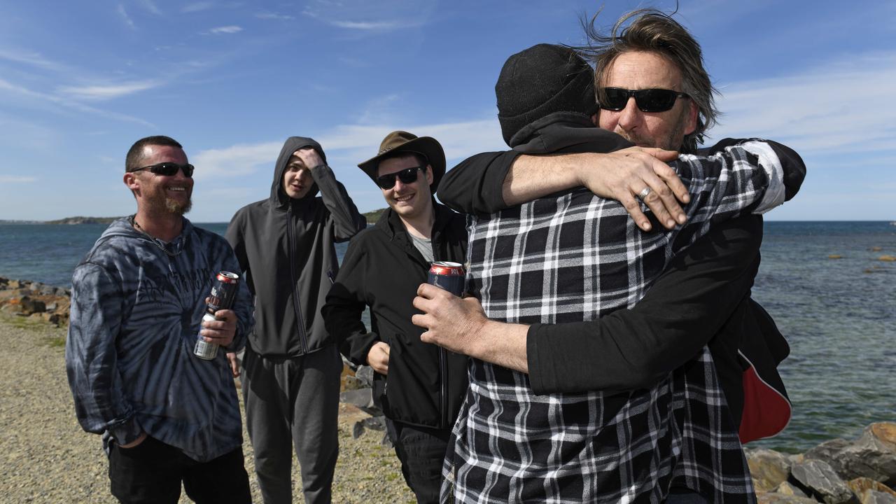 Derek Robinson is reunited with his family as he disembarks on to Granite Island. . Picture: NCA NewsWire / Picture: Naomi Jellicoe