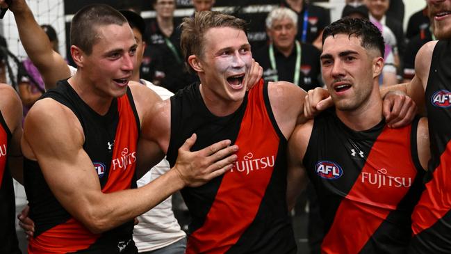 MELBOURNE, AUSTRALIA - MARCH 16: Sam Durham, Jake Kelly , Xavier Duursma, Jade Gresham and Ben McKay of the Bombers sing the song in the rooms after winning the round one AFL match between Essendon Bombers and Hawthorn Hawks at Melbourne Cricket Ground, on March 16, 2024, in Melbourne, Australia. (Photo by Quinn Rooney/Getty Images)