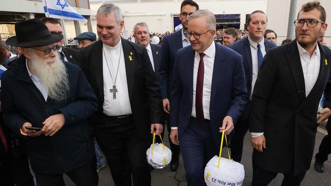 Prime Minister Anthony Albanese carries a lantern at a Melbourne vigil. Picture: NewsWire /Ian Currie