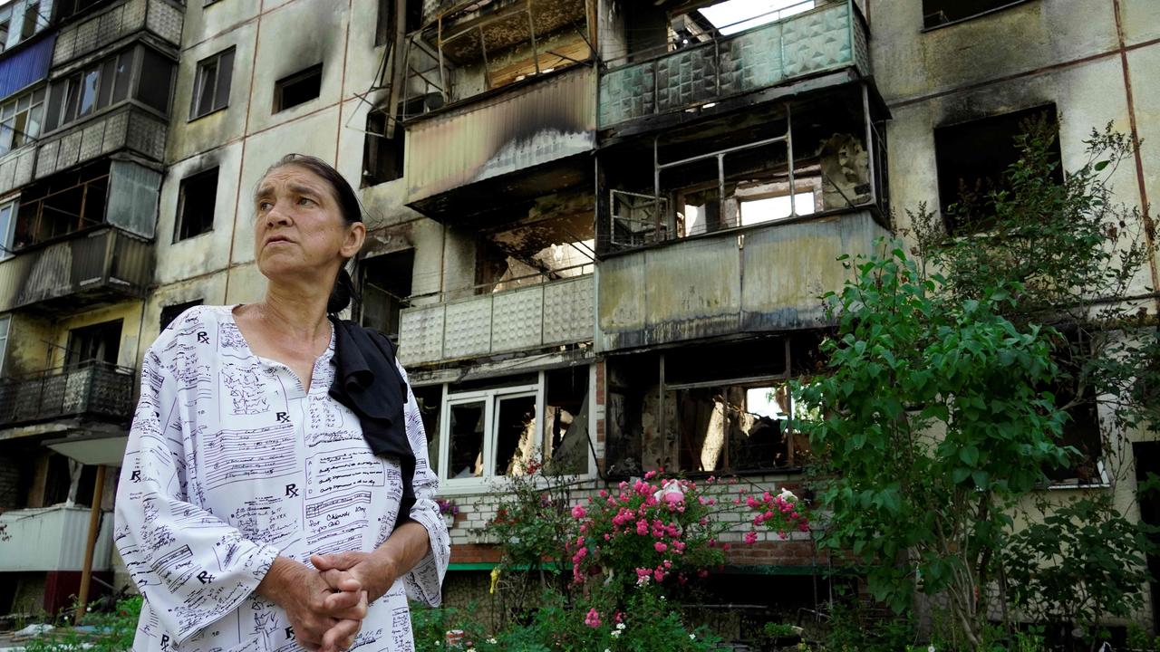 A woman walks past a building damaged by strikes in the town of Shebekino, near the Ukrainian border in Belgorod province. Picture: AFP