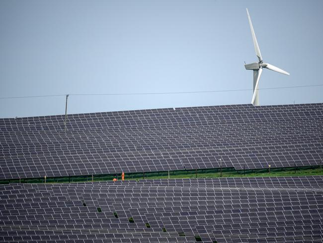 ANGLESEY, WALES - MAY 10: Wind turbines can be seen next to the Lightsource bp solar farm near the Anglesey village of Rhosgoch, May 10, 2024 in Wales. The farm was previously called Mon Solar and is now part of the Maen Hiron solar project. Plans have been submitted to build more solar farms on the island by Lightsource bp with a capacity of 350MW which will produce enough energy to power 133,106 homes and cover 12.34 sq km of farmland. (Photo by Christopher Furlong/Getty Images)