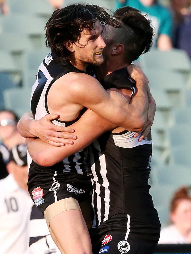 Kane Mitchell embraces Mason Shaw after the siren Picture: Sarah Reed