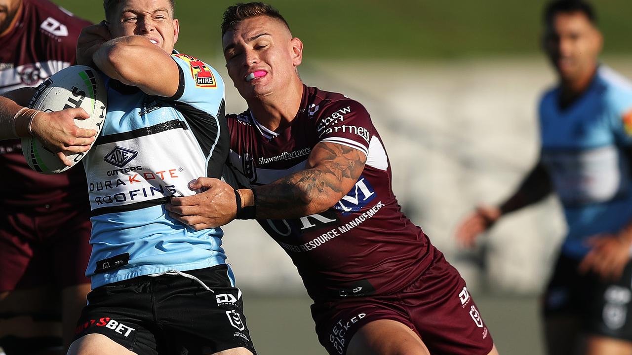 Danny Levi tackles Blayke Brailey in Manly’s trial against the Sharks.