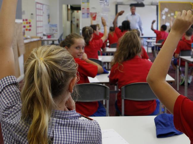 Port Melbourne Primary School Principal Peter Martin says the vertical school planned for South Melbourne will ease enrollment pressure at his school and bring the community together.Peter Martin in a mockup of an old fashioned classroom as his school only use the open plan system.Picture: Richard Serong