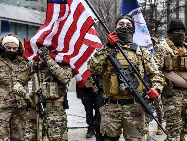 Members of a pro-gun group carry their weapons near the state Capitol in Richmond, Virginia, during the riots. Picture: AFP