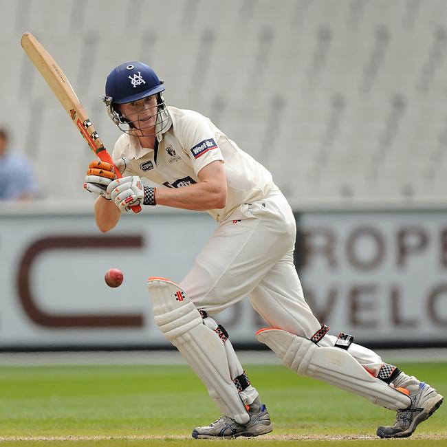 Alex Keath gets a shot away for Victoria in a match against England at the MCG in 2010.