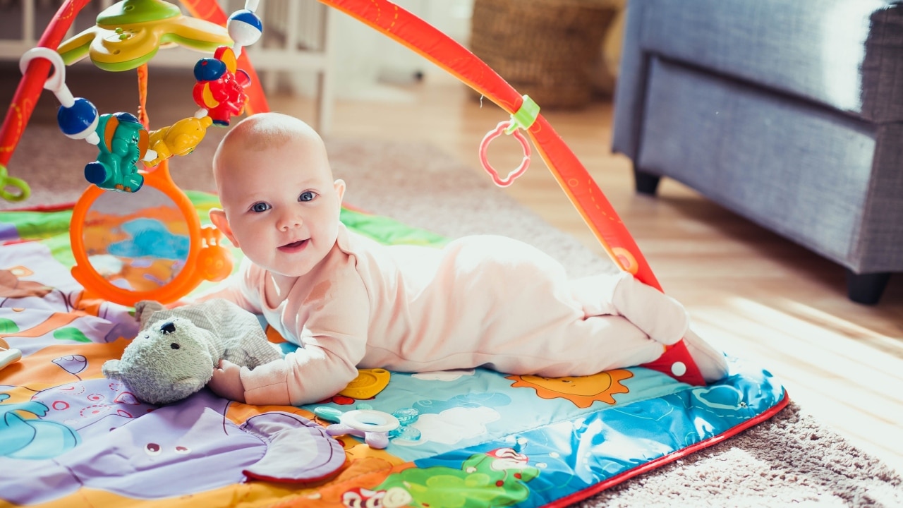 4 month old playing best sale with toys