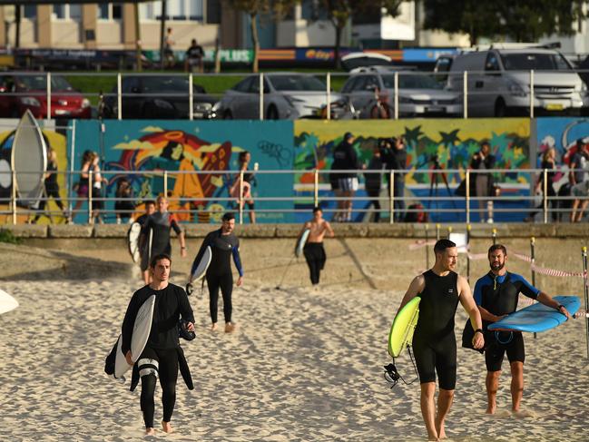 Surfers return to the water as Bondi Beach reopens to the public after closing following an outbreak of coronavirus. Picture: AAP