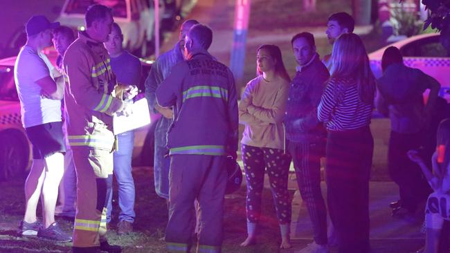 Firefighters talk to residents who were evacuated. Picture: Bill Hearne