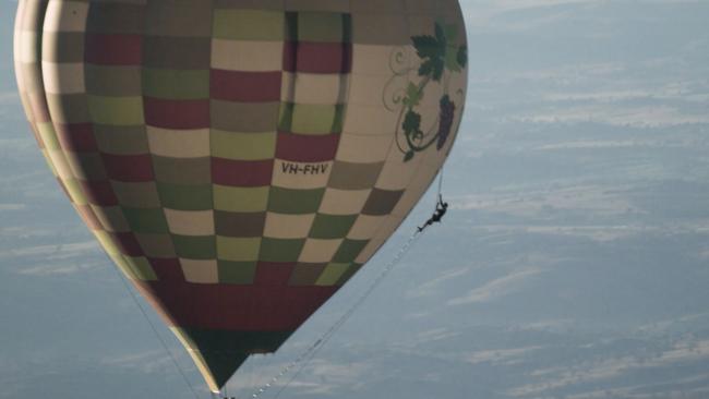 Gold Coast-based extreme athlete Damien Rider climbed up the side of a hot-air balloon 10,000 feet on a rope ladder above Bathurst and then parachuted off the top. Picture: Supplied.