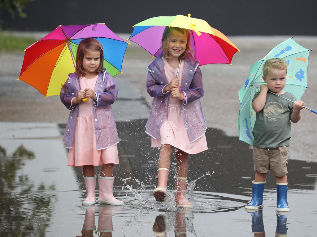 Indi, 4, Ella, 6, and Austin, 3, Crampton from Bulimba get wet on New Year’s Day. Pic Annette Dew