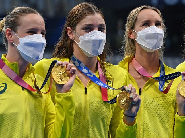 Gold medallists (from L) Australia's Bronte Campbell, Australia's Meg Harris, Australia's Emma Mckeon and Australia's Cate Campbell pose after the final of the women's 4x100m freestyle relay swimming event during the Tokyo 2020 Olympic Games at the Tokyo Aquatics Centre in Tokyo on July 25, 2021. (Photo by Jonathan NACKSTRAND / AFP)