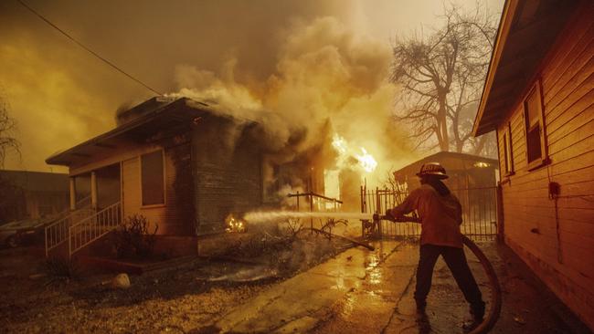 A firefighter battles the Eaton Fire Wednesday, Jan. 8. Picture: AP Photo/Ethan Swope