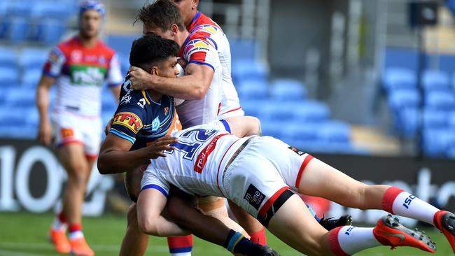 Peachey is tackled by the Knights. Picture: Getty Images