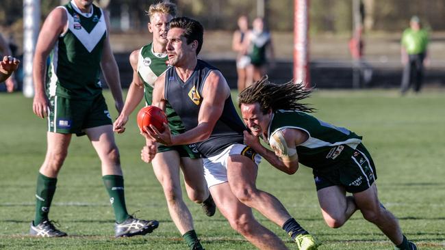 Scotch’s Jonathon Lagonik is tackled by Seaton’s Shane Harris in the 2018 division three grand final. Picture: AAP/Morgan Sette