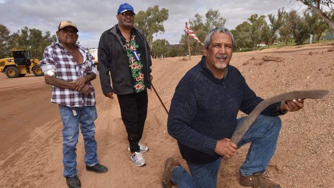 Native Title holder Ian Liddle, Nick Campbell and Michael Liddle, holding an ancient boomerang found by council workers. PIC: REX NICHOLSON