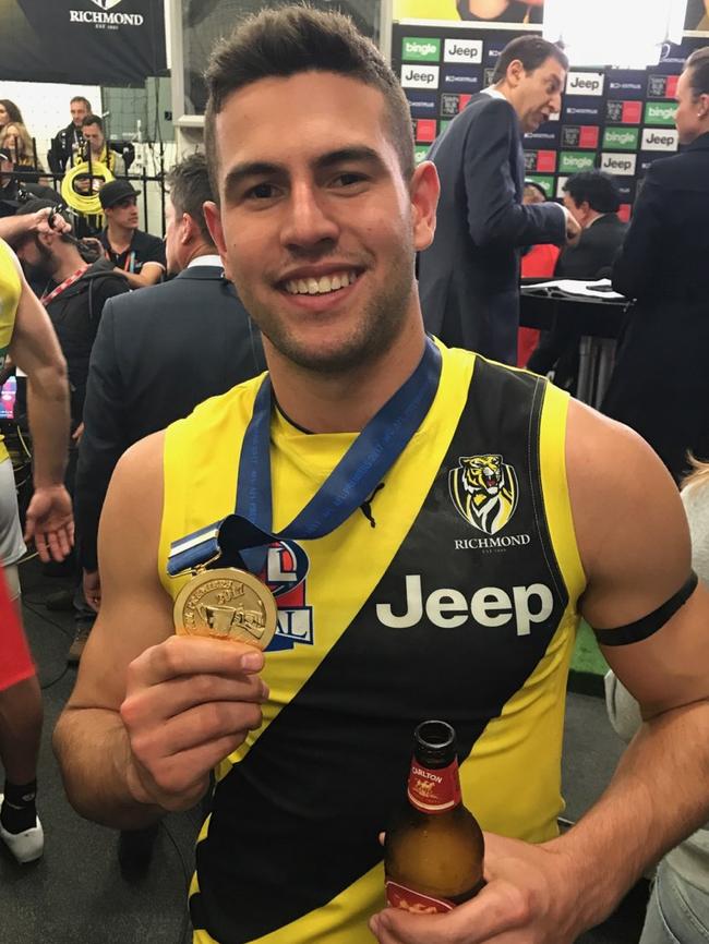 Jack Graham shows off his premiership medal.