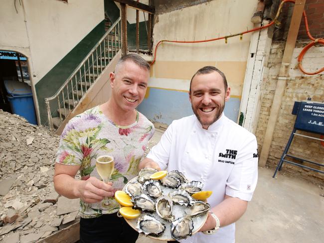 The Smith co-owner Scott Borg and chef/co-owner Brad Simpson dressed up with champagne and fish and chips. Picture Norm Oorloff