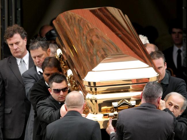 The gold coffin with the body of gangland killer Carl Williams leaves the funeral service at a church in Essendon. Picture: Stuart McEvoy