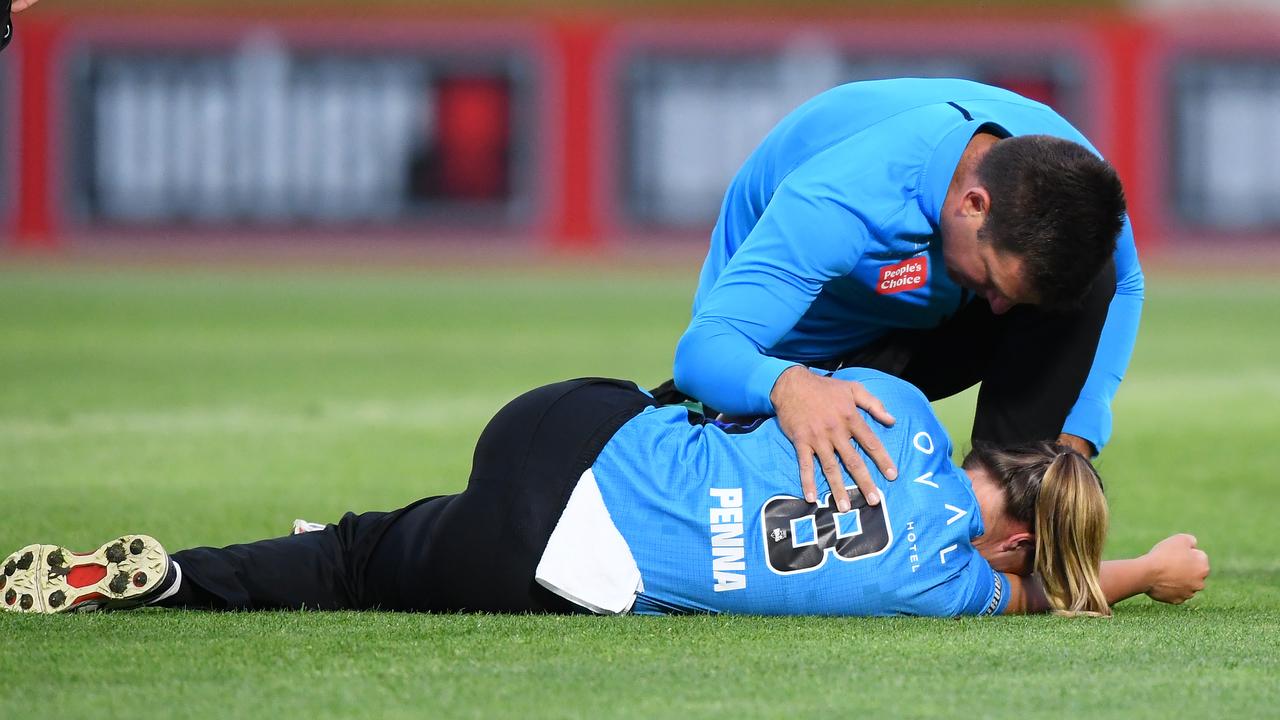 The Strikers team doctor assists Maddie Penna. Photo by Mark Brake/Getty Images