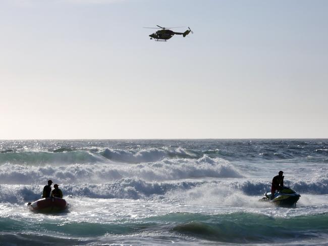 Multiple aircraft, boats and jet skis are searching for the missing teen amid the surf. Picture: John Fotiadis