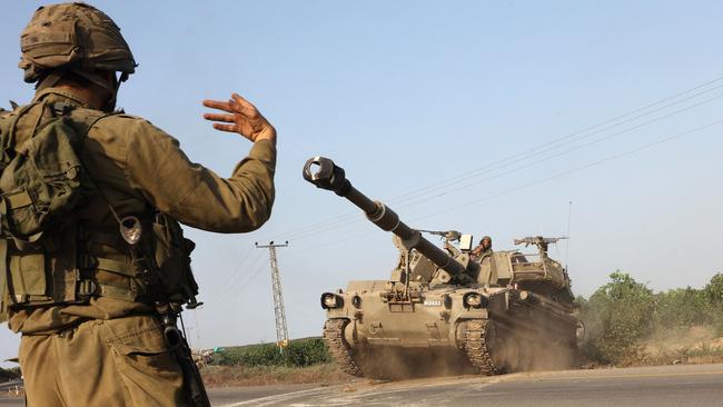 An Israeli soldier directs a self-propelled howitzer near the southern city of Ashkelon on Sunday. Picture: AFP