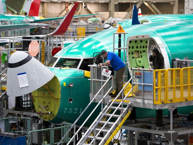 (FILES) (FILES) Employees work on Boeing 737 MAX airplanes at the Boeing Renton Factory in Renton, Washington on March 27, 2019. Boeing reported a whopping $6.2 billion quarterly loss October 23, 2024 as a nearly six-week labor strike weighed on its commercial plane division and costly problems dragged down its defense and space business. (Photo by Jason Redmond / AFP)