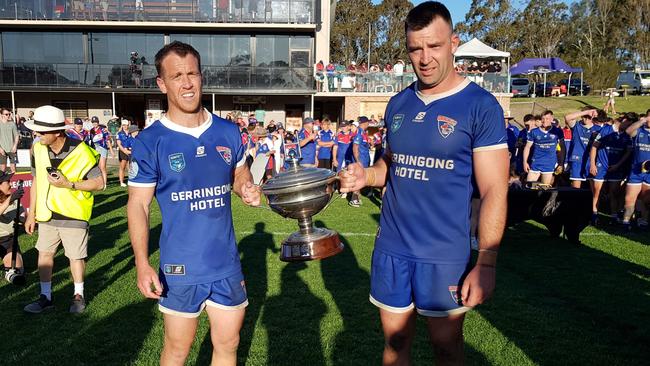 Rixon Russell and Nathan Ford hold the Illawarra Cup trophy for Gerringong Lions. Picture: Steve Montgomery Sports Photography