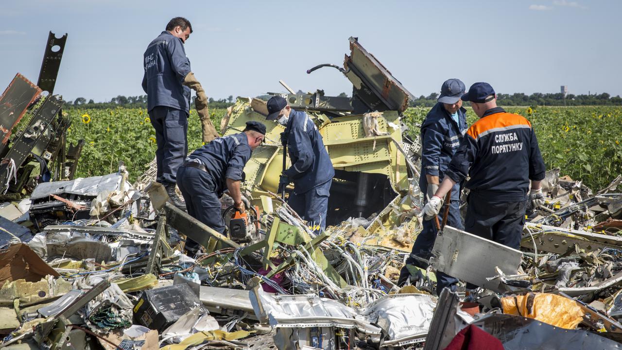 Ukrainian rescue servicemen inspect part of the wreckage of Malaysia Airlines flight MH17. Picture: Rob Stothard/Getty Images