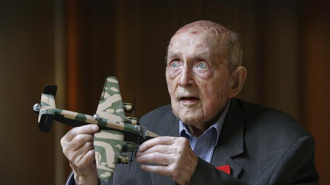 Laurie Larmer, now 98, holds a model of a Halifax bomber that he flew during the war when he was just 21. Picture: David Caird